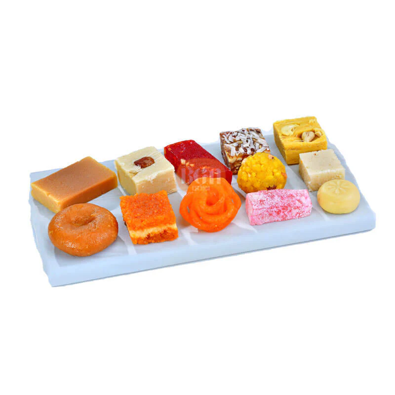 Assorted Indian sweets box with laddu, barfi, peda and traditional mithai on plate