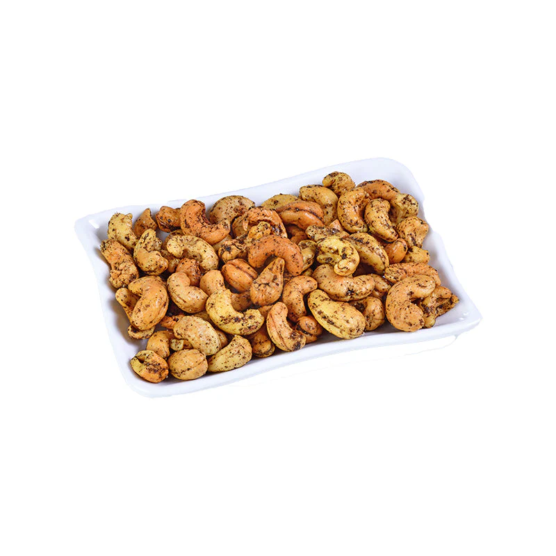 A white tray filled with cashew fry, featuring roasted cashew nuts coated with spices and herbs, giving them a golden-brown appearance.